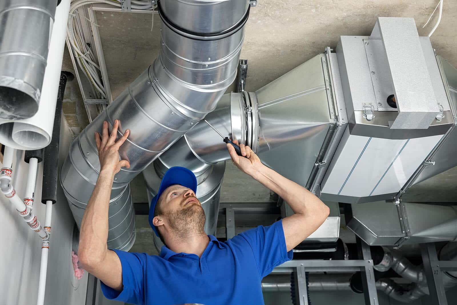 HVAC technician inspecting and repairing air ducts in Culver City