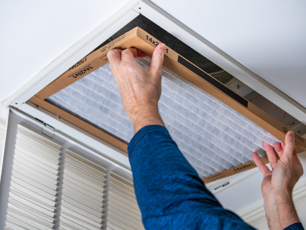 HVAC technician replacing a home air filter in Culver City