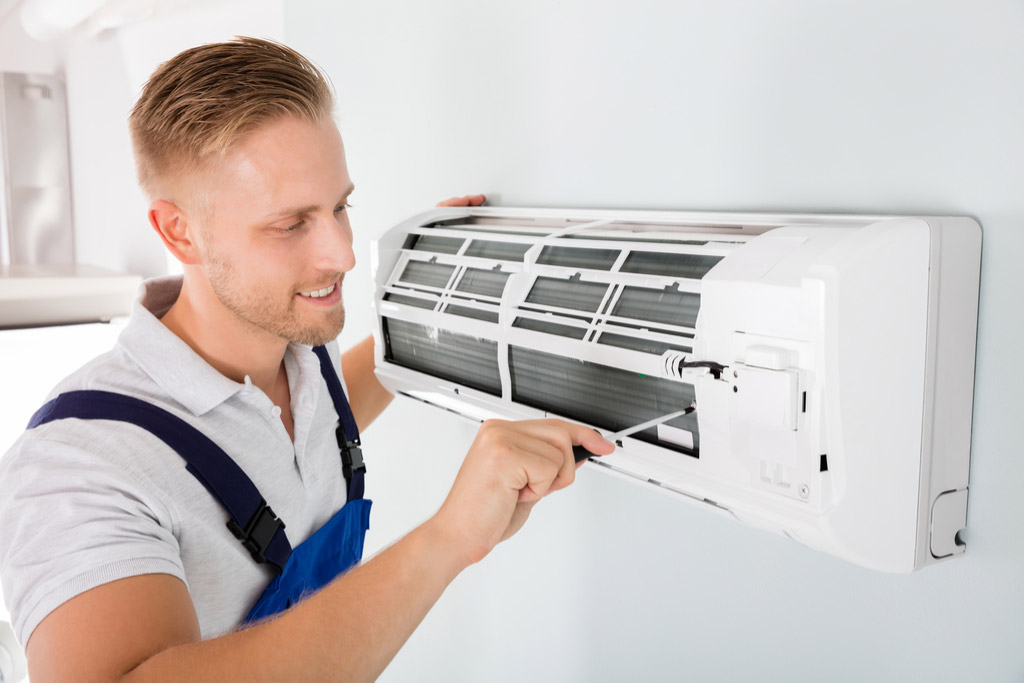 HVAC technician maintaining a ductless air conditioner in Culver City