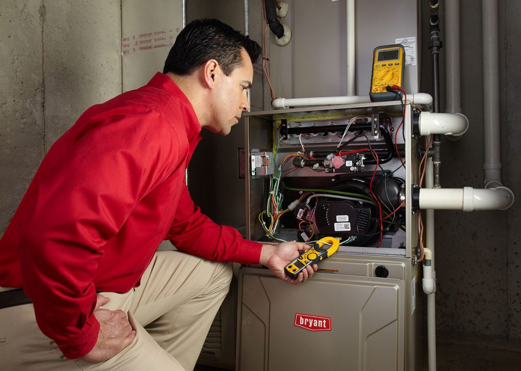 Heating technician diagnosing a furnace repair in Culver City