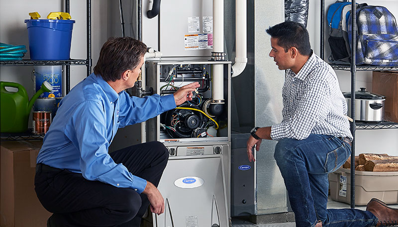 Technician evaluating a furnace for repair or replacement in Culver City