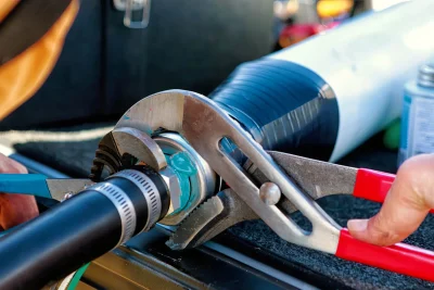 Technician repairing an industrial pipe connection in Culver City