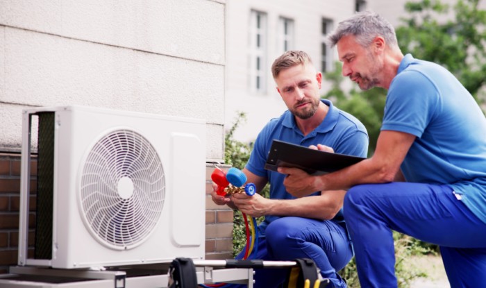 HVAC technicians installing an outdoor air conditioning unit in Culver City